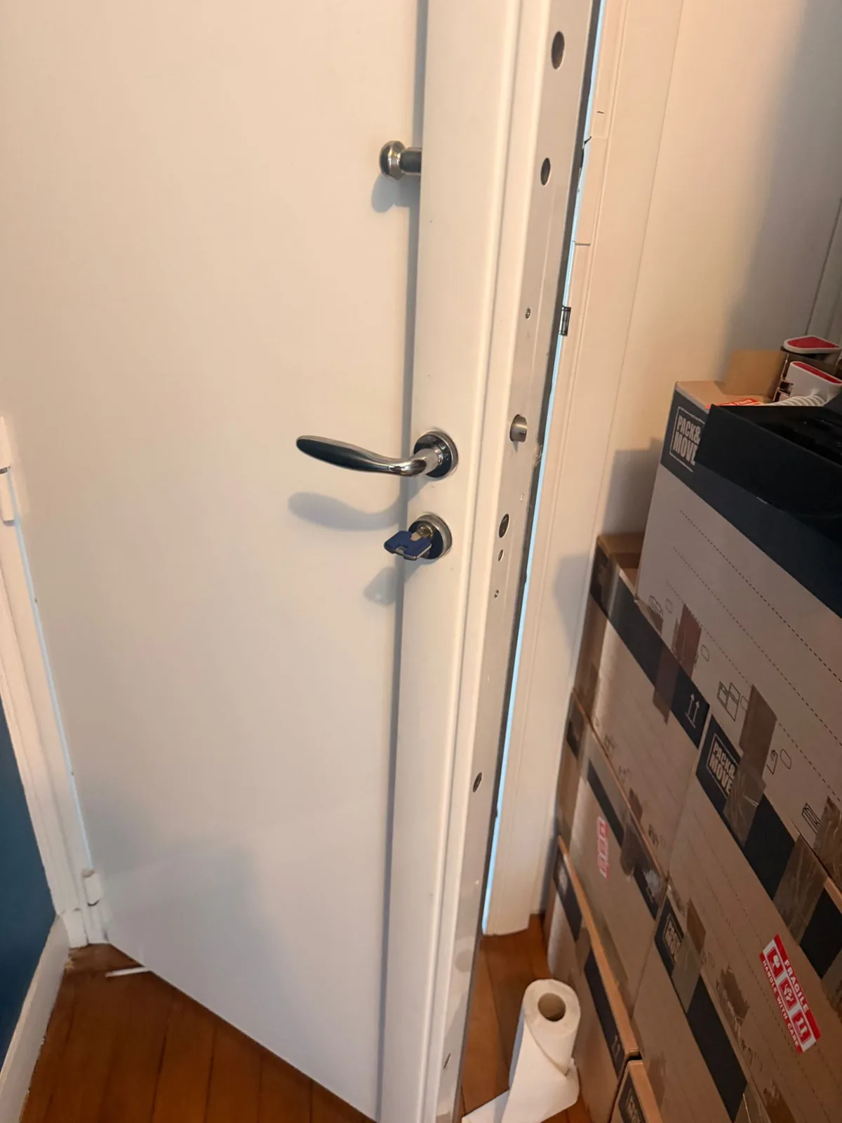 White armored door fitted with a multi-point security lock