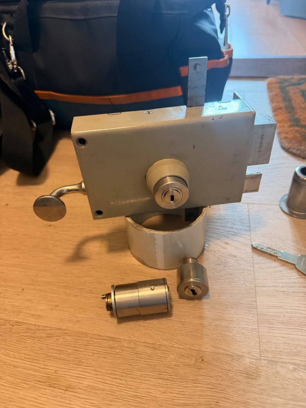 Surface-mounted lock and cylinders removed for replacement
